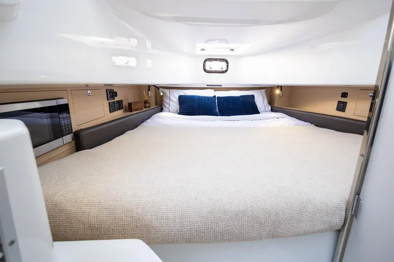 Slide: The Image of 2026 Wellcraft 38 T-Top cabin interior with bed, microwave, and modern amenities. - 66