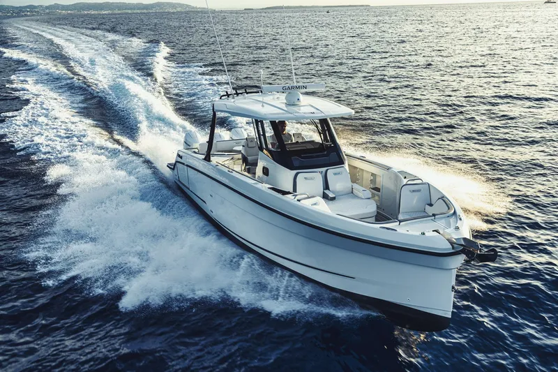 Slide: The Image of 2026 Wellcraft 38 T-Top boat cruising on open water, creating a dynamic wake. - 67