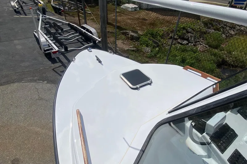 Slide: The Image of 1991 Eastern Lobsterman boat on trailer, parked outdoors, showing deck and hatch. - 8
