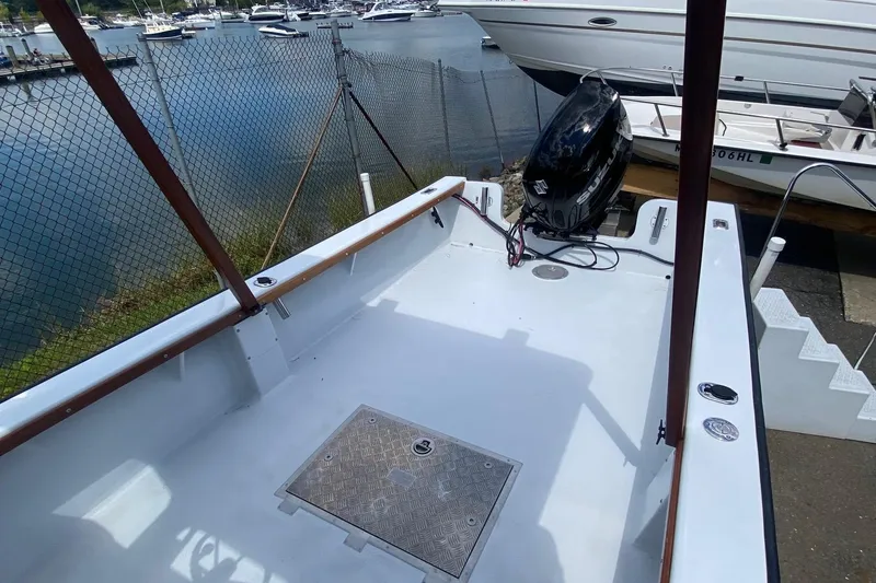 Slide: The Image of 1991 Eastern Lobsterman boat with outboard motor, docked near marina. - 9