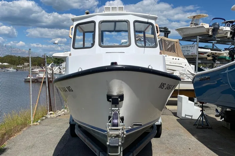 Slide: The Image of 1991 Eastern Lobsterman boat on trailer, dockside with clear sky background. - 1