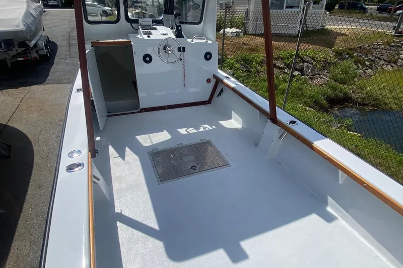 Slide: The Image of 1991 Eastern Lobsterman boat interior with steering wheel and open deck. - 4