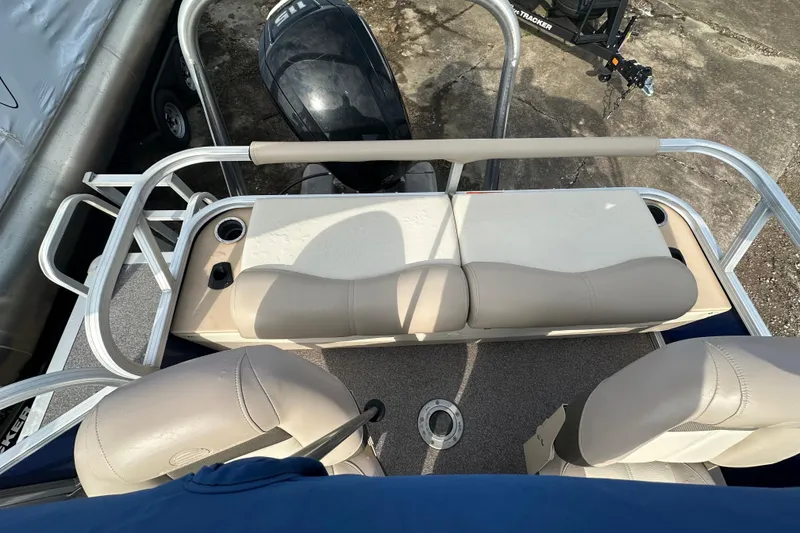 Slide: The Image of 2015 Sun Tracker Fishin' Barge 22 DLX interior with seating and motor view. - 10