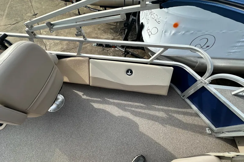 Slide: The Image of 2015 Sun Tracker Fishin' Barge 22 DLX interior with seating and railing details. - 11