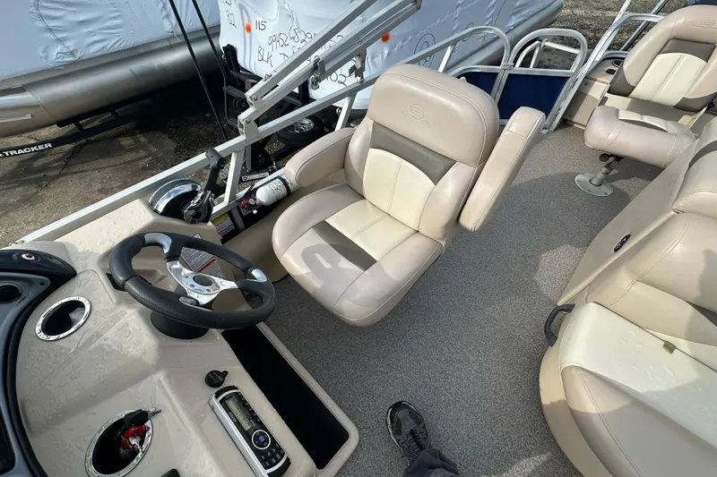 Slide: The Image of 2015 Sun Tracker Fishin' Barge 22 DLX interior with steering wheel and seating. - 14