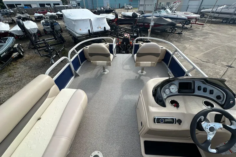 Slide: The Image of 2015 Sun Tracker Fishin' Barge 22 DLX pontoon boat interior with seating and control panel. - 17
