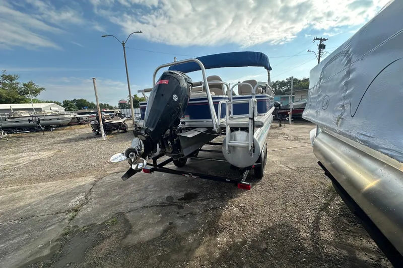 Slide: The Image of 2015 Sun Tracker Fishin' Barge 22 DLX pontoon boat with outboard motor in a marina. - 3