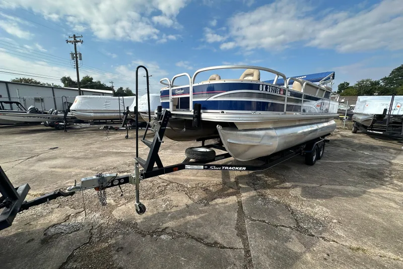 Slide: The Image of 2015 Sun Tracker Fishin' Barge 22 DLX pontoon boat on trailer, outdoor storage. - 4