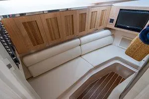 Slide: The Image of 2026 Grady-White Freedom 345 cabin interior with wood paneling and white seating. - 10