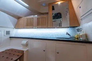 Slide: The Image of Interior of 2026 Grady-White Freedom 345 boat, featuring modern cabinetry and lighting. - 11