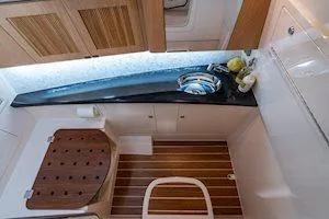 Slide: The Image of 2026 Grady-White Freedom 345 interior with sleek design, wooden accents, and modern amenities. - 3