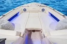 Slide: The Image of 2026 Grady-White Freedom 345 boat interior with cushioned seating and ocean backdrop. - 6
