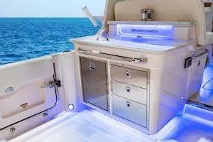 Slide: The Image of 2026 Grady-White Freedom 345 boat interior with sleek cabinetry and ocean view. - 7