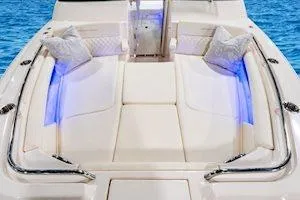 Slide: The Image of 2026 Grady-White Freedom 345 boat interior with plush seating and ambient lighting. - 9