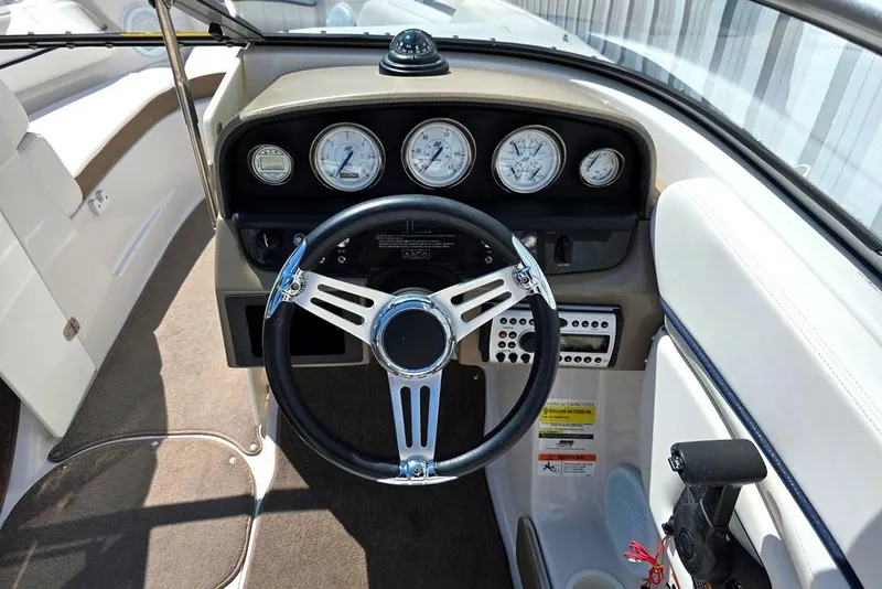 Slide: The Image of 2007 Four Winns 210 Horizon SS BR boat dashboard with steering wheel and gauges. - 13