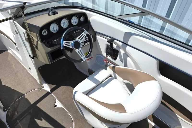Slide: The Image of 2007 Four Winns 210 Horizon SS BR boat interior with steering wheel and dashboard controls. - 2
