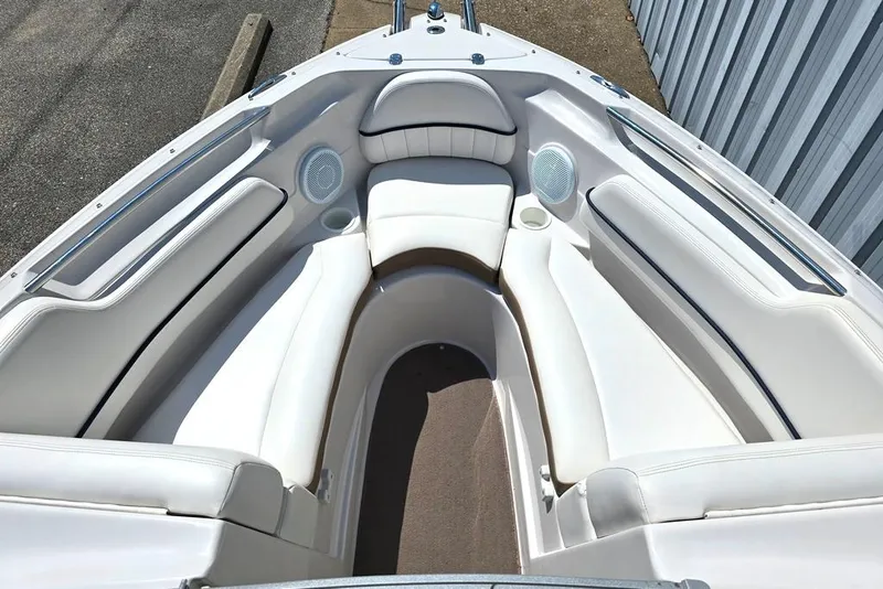 Slide: The Image of 2007 Four Winns 210 Horizon SS BR boat interior with white seating and speakers. - 4