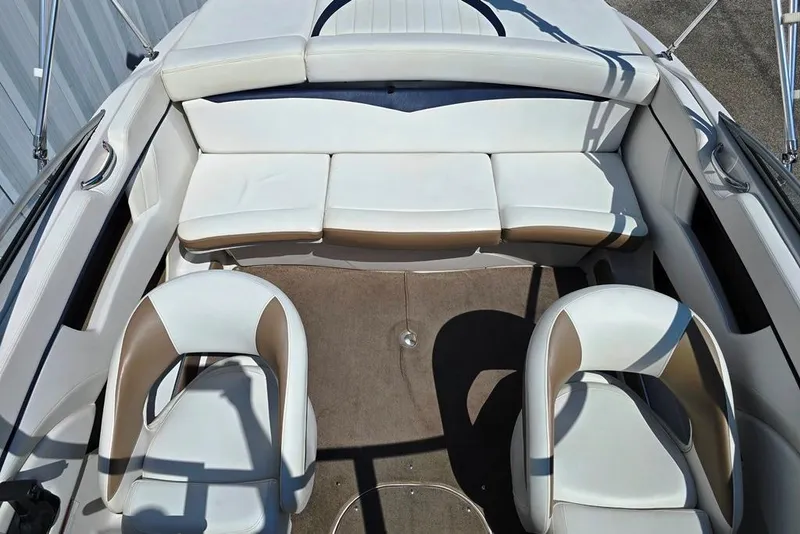 Slide: The Image of 2007 Four Winns 210 Horizon SS BR boat interior with white seating and carpeted floor. - 5