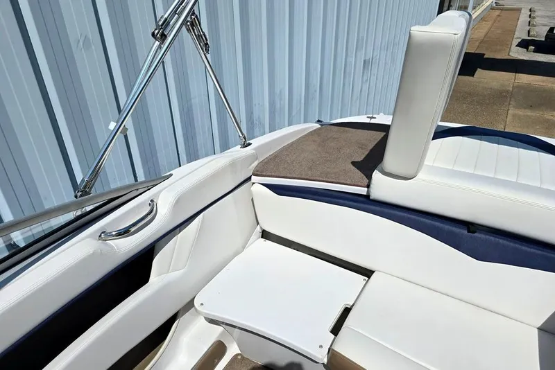 Slide: The Image of 2007 Four Winns 210 Horizon SS BR boat interior with white seating and stainless steel details. - 7