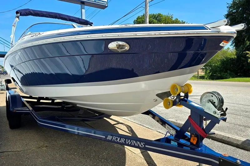 Slide: The Image of 2007 Four Winns 210 Horizon SS BR boat on trailer, blue and white design. - 8