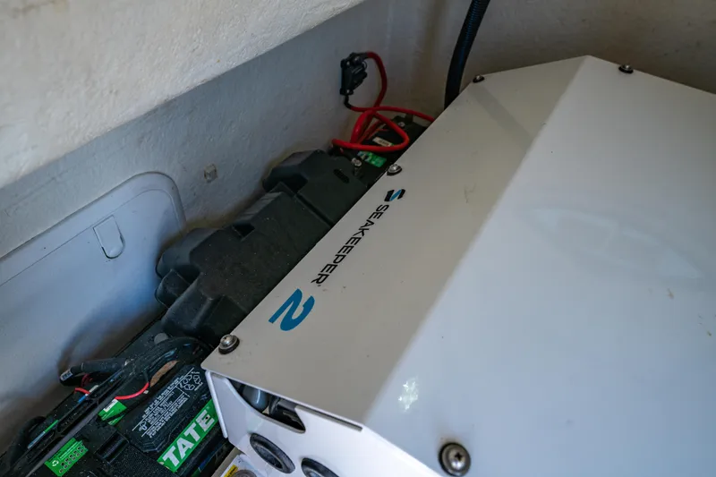 Slide: The Image of 2022 Twin Vee 280 GFX CC boat interior with mechanical components and battery. - 11