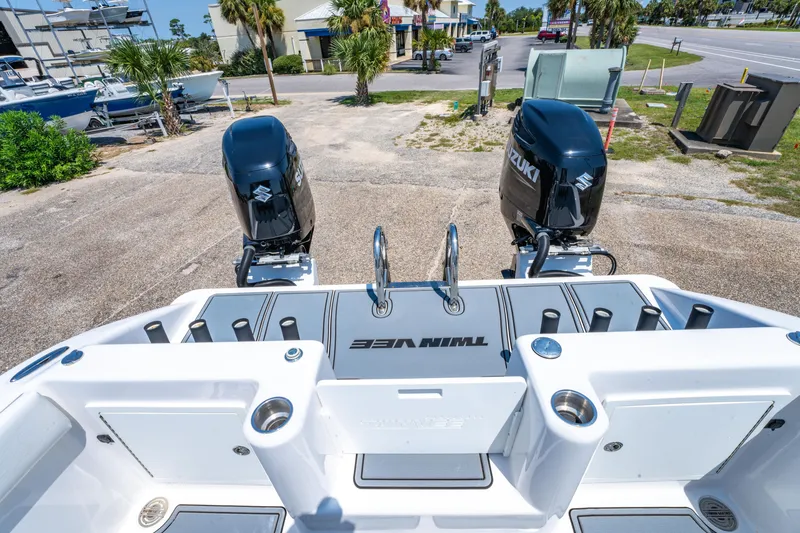 Slide: The Image of 2022 Twin Vee 280 GFX CC boat with dual Suzuki outboard motors, docked on a sunny day. - 17