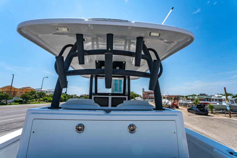 Slide: The Image of 2022 Twin Vee 280 GFX CC boat, rear view, sunny day, marina background. - 19