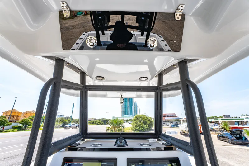 Slide: The Image of 2022 Twin Vee 280 GFX CC boat console with modern controls and cityscape view. - 21