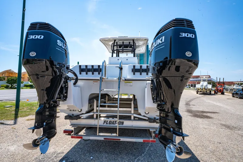 Slide: The Image of 2022 Twin Vee 280 GFX CC boat with dual Suzuki engines on a trailer. - 5