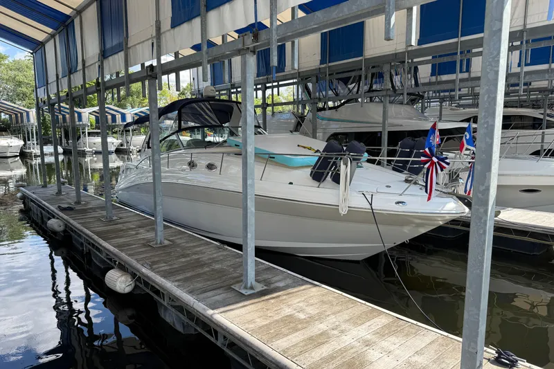 Slide: The Image of 2006 Sea Ray 340 Sundancer docked in a marina with covered slips. - 0