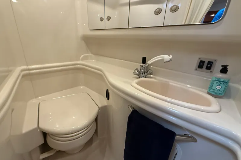 Slide: The Image of 2006 Sea Ray 340 Sundancer bathroom with sink, toilet, and mirror cabinet. - 13