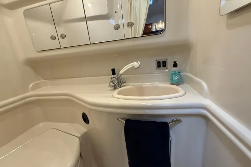 Slide: The Image of 2006 Sea Ray 340 Sundancer bathroom with sink, mirror, and toiletries. - 15