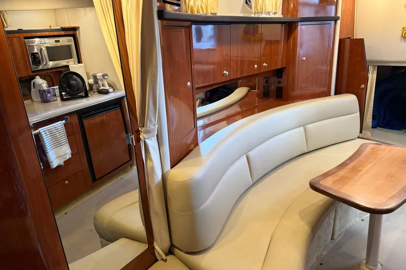 Slide: The Image of Luxurious interior of 2006 Sea Ray 340 Sundancer with kitchenette and curved seating. - 16