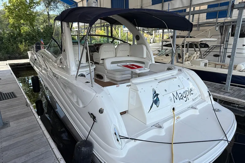 Slide: The Image of 2006 Sea Ray 340 Sundancer docked, featuring a spacious deck and canopy. - 3