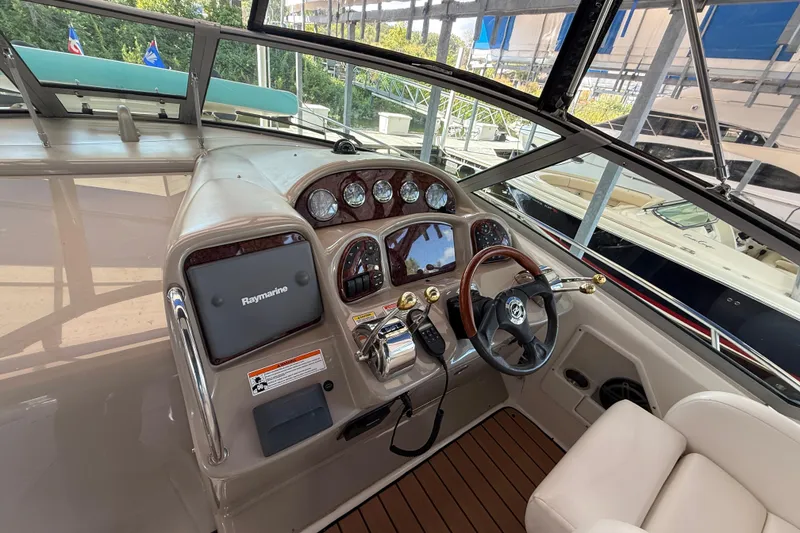 Slide: The Image of 2006 Sea Ray 340 Sundancer helm with Raymarine electronics and wood-accented steering wheel. - 7