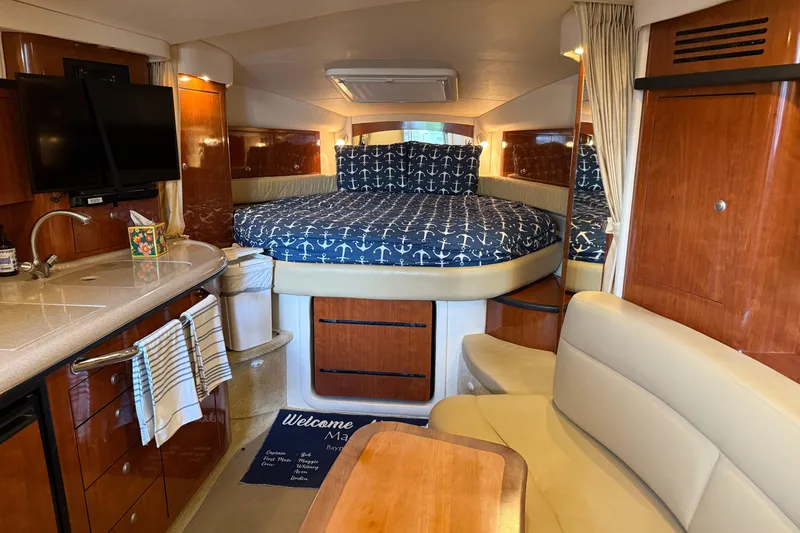 Slide: The Image of Interior of 2006 Sea Ray 340 Sundancer yacht with cozy bed and kitchenette. - 8