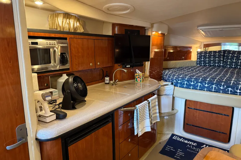 Slide: The Image of Interior of 2006 Sea Ray 340 Sundancer with kitchenette and cozy sleeping area. - 9