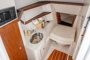 Slide: The Image of 2026 Grady-White Freedom 325 boat interior with sink and seating area. - 10