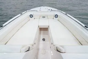 Slide: The Image of 2026 Grady-White Freedom 325 boat interior with spacious seating on calm water. - 8