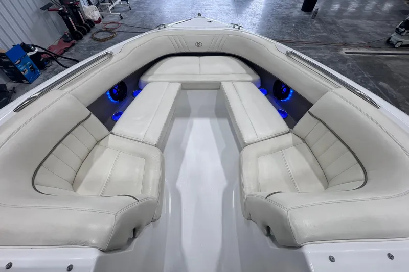 Slide: The Image of 2006 Cobalt 232 boat interior with white seating and blue LED lights. - 10