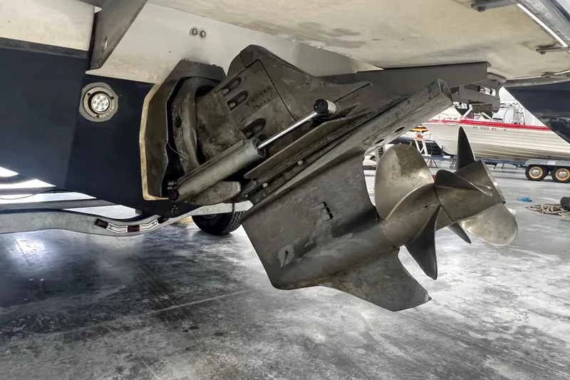 Slide: The Image of Close-up of a 2006 Cobalt 232 boat propeller and stern drive in a garage. - 13