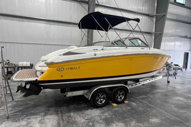 Slide: The Image of Yellow 2006 Cobalt 232 boat on trailer in indoor storage facility. - 3