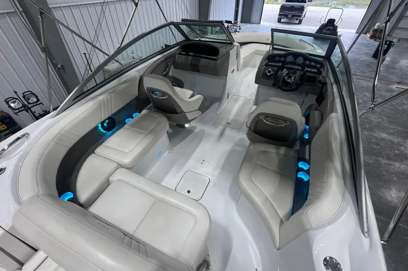 Slide: The Image of 2006 Cobalt 232 boat interior with white seating and blue accent lighting. - 5