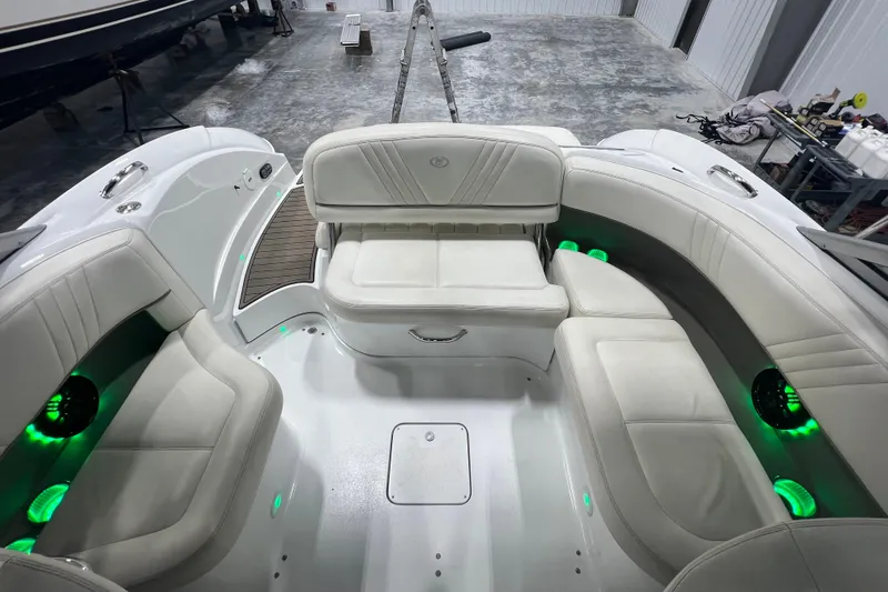 Slide: The Image of 2006 Cobalt 232 boat interior with white seating and green LED lights. - 6