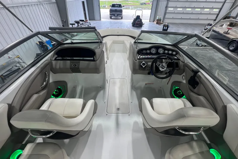 Slide: The Image of Interior of a 2006 Cobalt 232 boat with modern dashboard and seating. - 7