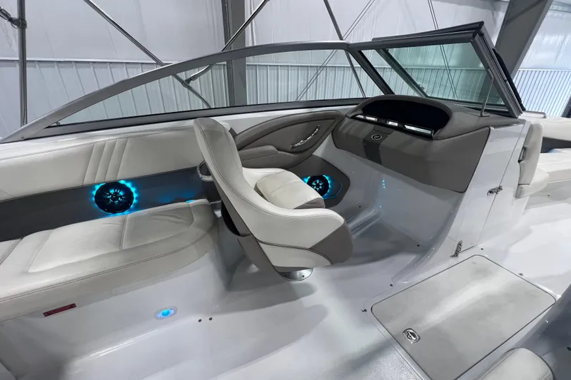 Slide: The Image of Interior of a 2006 Cobalt 232 boat with modern seating and illuminated speakers. - 9