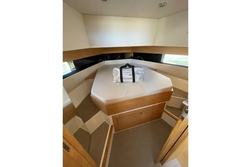 Slide: The Image of 2021 De Antonio Yachts Center Console cabin interior with modern design and comfortable bedding. - 12