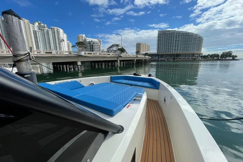 Slide: The Image of 2021 De Antonio Yachts Center Console docked near urban waterfront, clear sky. - 13