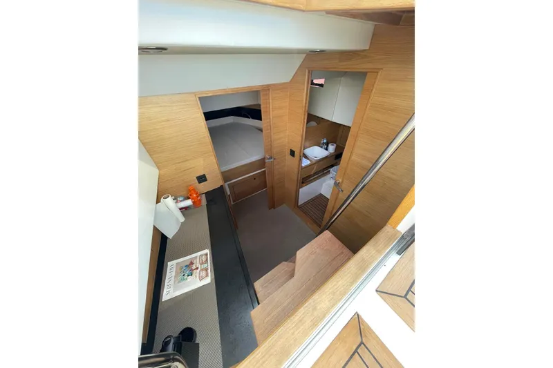 Slide: The Image of Interior of 2021 De Antonio Yachts Center Console, featuring modern wood finishes and compact design. - 14