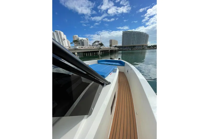 Slide: The Image of 2021 De Antonio Yachts Center Console on calm water, cityscape in background. - 16